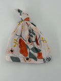 theOVer.co Baby Hat 0-3m Cream with floral pattern in orange, grey, and black